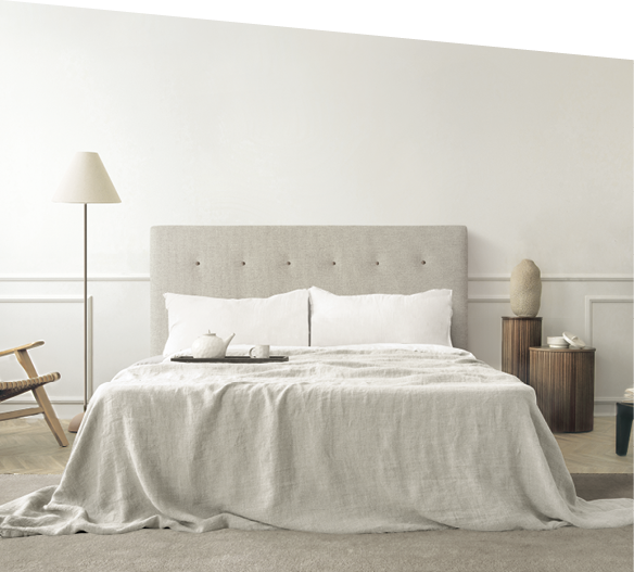 Cozy bedroom interior with mock up poster frame, big bed, beige bedding, plaid, lamp, wooden stands, black ladder, beige rug, wall with stucco and personal accessories. Home decor. Template.